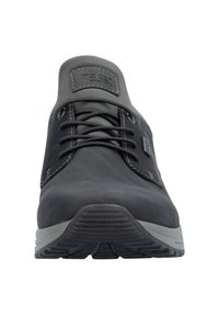 Gray lace-up shoe with a smooth synthetic upper, contrasting light stitching, and a textured rubber sole. Features a branded tag on the tongue.