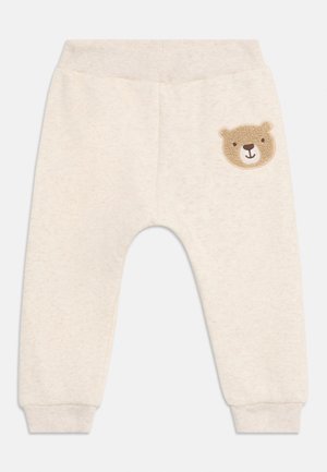 Lichtbeige katoenen joggers met geribbelde tailleband en boorden. Bevat een geborduurd berengezicht appliqué op het linkerbeen.