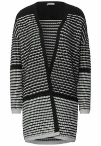 Černobílý pletený kardigan s výstřihem do V, zdobený geometrickými pruhy a volným střihem. Lemovaný žebrovanými okraji.