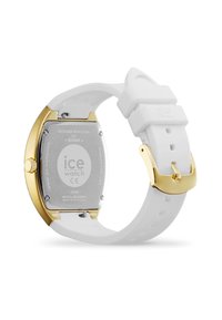 Orologio con cinturino in silicone bianco, cassa in acciaio inossidabile lucido e fibbia color oro, dotato di un retro circolare in metallo con dettagli incisi.