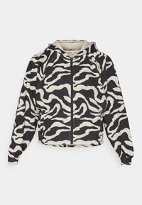 Afskåret hættetrøje med et sort og cremefarvet zebra-mønster. Har en frontlynlås og en hætte, med ribbet mansjetter og nederste kant.