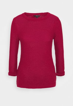 Dzianinowy sweter z długim raglanowym rękawem w jaskrawej czerwieni, z okrągłym dekoltem, rękawami do łokcia i ściągaczami na mankietach. Całość wykonana z fakturowanej tkaniny.