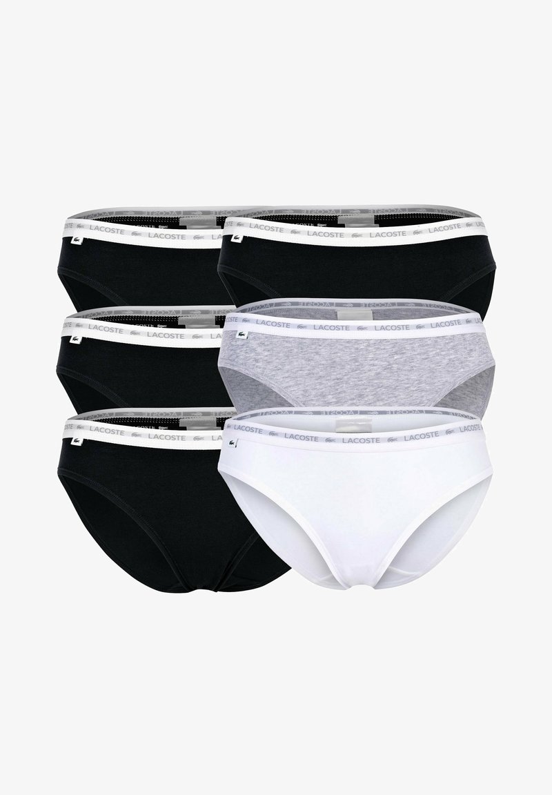 Pięć par damskich majtek w kolorach czarnym, białym i szarym. Posiadają miękki elastyczny pas z logo Lacoste. Wykonane z mieszanki bawełny.