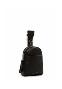 Small black leather crossbody bag with silver zipper, wide adjustable strap, and front pocket, embossed with brand logo.