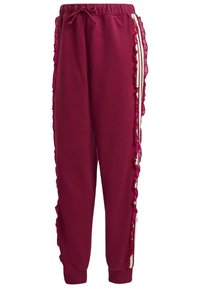 Bordové tepláky s rýhovanými bočními detaily, elastickým pasem, stahovací šňůrkou a pruhovaným akcentem po stranách. Měkká textilie.