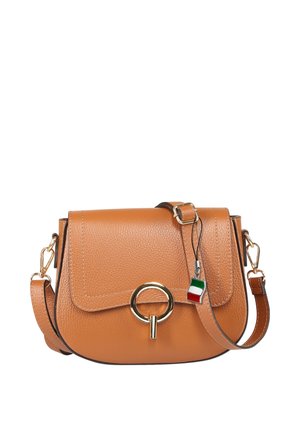 Tan leather crossbody bag with gold circular clasp, adjustable strap, and small keychain charm featuring the Italian flag colors.