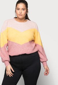 Knitted sweater with a round neck, featuring a chevron pattern in pink, yellow, and orange. Long sleeves, soft texture, and relaxed fit.
