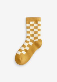 Gelbe Socke mit einem karierten Muster in Weiß. Hergestellt aus weicher Stoff, verfügt sie über einen gerippten Bund und ein klassisches Crew-Längen-Design.