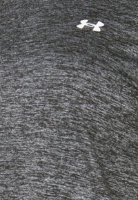Gray athletic t-shirt with a textured fabric. Features a small white Under Armour logo on the chest.