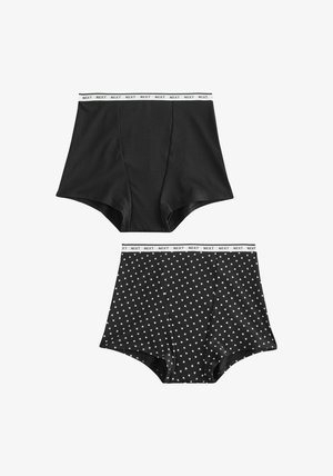 Súprava čierneho bavlneného spodného prádla s vysokým pásom. Obsahuje jeden kus v pevnej čiernej farbe a druhý so vzorom malých bielych srdiečok, oba s bielym pásom s logom značky.
