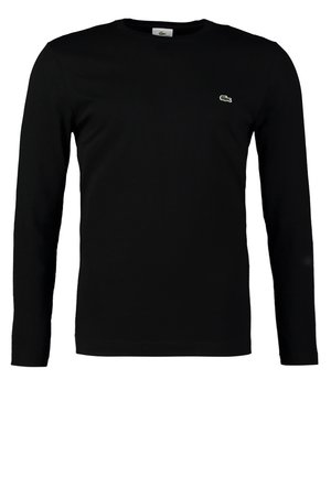 T-shirt à manches longues noir en coton. Présente un logo brodé vert sur la poitrine. Design simple et ajusté avec un col rond.