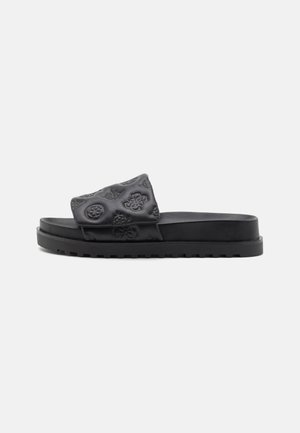 Sandalo a slip-on nero con parte superiore testurizzata che presenta motivi in rilievo, suola piatta e bordi seghettati per una migliore presa. Realizzato in materiale sintetico.