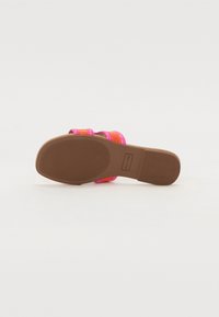 Vibrant, multicolored sandals with a smooth, shiny finish. Features two wide straps in orange and hot pink with a textured brown sole.