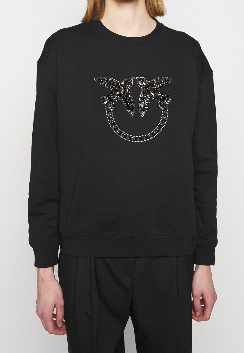 Felpa nera con grafica trapuntata e paillettes raffigurante due farfalle all'interno di un disegno circolare sul davanti. Polsini e orlo a costine.