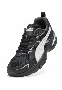 Black athletic shoe with a mesh upper, featuring a white Puma logo and accents, a cushioned sole, and a textured finish.