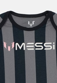 Black and gray striped shirt with a crew neckline. Features a large white "MESSI" logo and a pink accent logo on the left side.