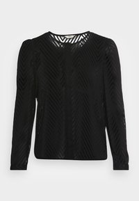 Blusa de manga longa preta com um padrão de ziguezague, tecido texturizado, decote redondo e material semi-transparente.