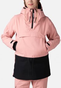 Rosa vattentät anorakjacka med en svart nederdel, har en justerbar huva, framficka och elastiska ärmslut. Slät textur.
