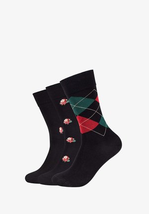 Tre paia di calzini neri con motivi diversi: uno con motivi natalizi di Babbo Natale, uno con un motivo geometrico in rosso e verde, e uno completamente nero.
