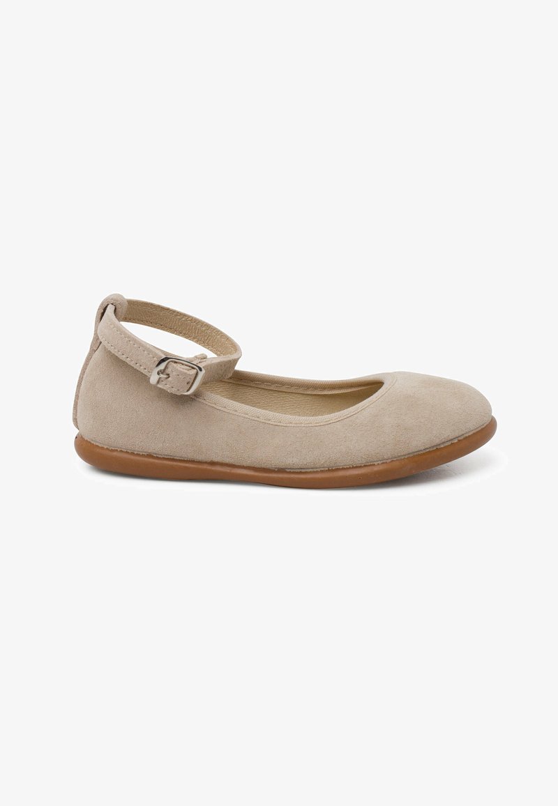 Beige suede ballet flat with rounded toe, adjustable ankle strap, and flexible brown rubber sole. Smooth texture, minimalist design.