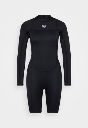 Combinaison de plongée noire à manches longues, fabriquée en néoprène extensible. Présente un col rond et un petit logo sur la poitrine.