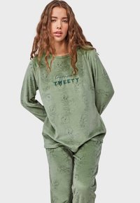 Green pajama set in soft fabric featuring an all-over Tweety bird pattern, with the text "happiness is TWEETY" in dark green embroidery.