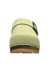 Light green suede clogs with a dark strap, metal buckle, and contrasting stitching. Wood base with a textured sole.