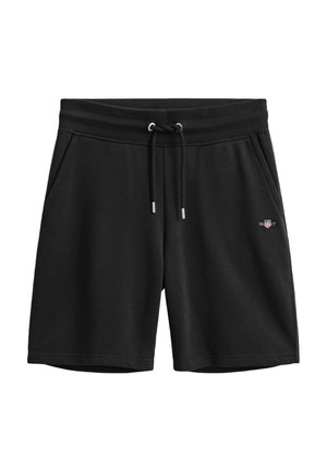 Schwarze Freizeithose mit Kordelzugbund, Seitentaschen und kleinem GANT-Logo am rechten Oberschenkel.