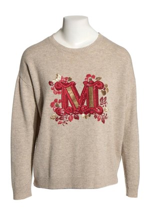 Beżowy sweter dziany z czerwonym i złotym haftowanym literem M otoczonym czerwonymi i złotymi kwiatowymi wzorami z przodu.