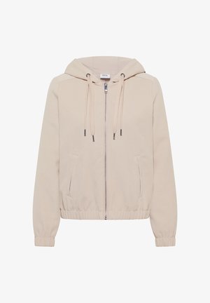 Jasna beżowa kurtka z kapturem, zapinana na suwak z przodu, z elastycznymi mankietami i dołem; posiada dwie boczne kieszenie oraz sznurki do regulacji kaptura.