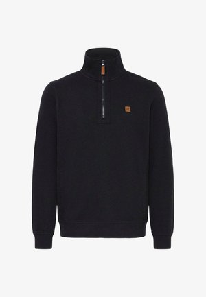 Crni pulover s visokom ovratnikom i polu zatvaračem. Sadrži malu teksturiranu oznaku i rebraste manžete i donji rub. Mekana tkanina.