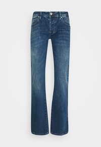 Modre denim kavbojke z obliko hlačnic v obliki zvona, srednjim pasom, klasičnim petim žepom in subtilnim zbledelostjo za teksturo.