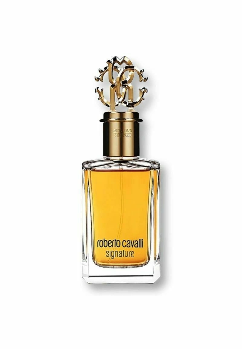 Roberto Cavalli Signature parfym i en klar rektangulär glasflaska, med ett guldornamenterat lock och ambra-färgad vätska inuti.