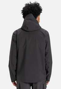 Black waterproof jacket with a hood, featuring a smooth texture, relaxed fit, and no visible logos or embellishments on the back.