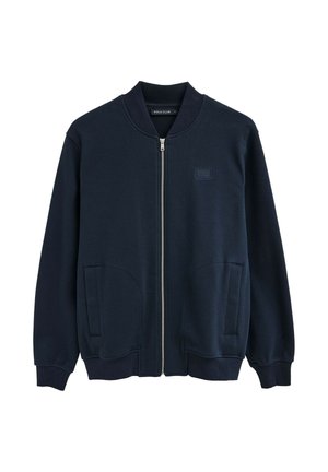 Marineblaue Bomberjacke mit Reißverschluss, geripptem Kragen und Bündchen, Vorderentaschen und kleinem "Polo Club"-Logo auf der Brust.