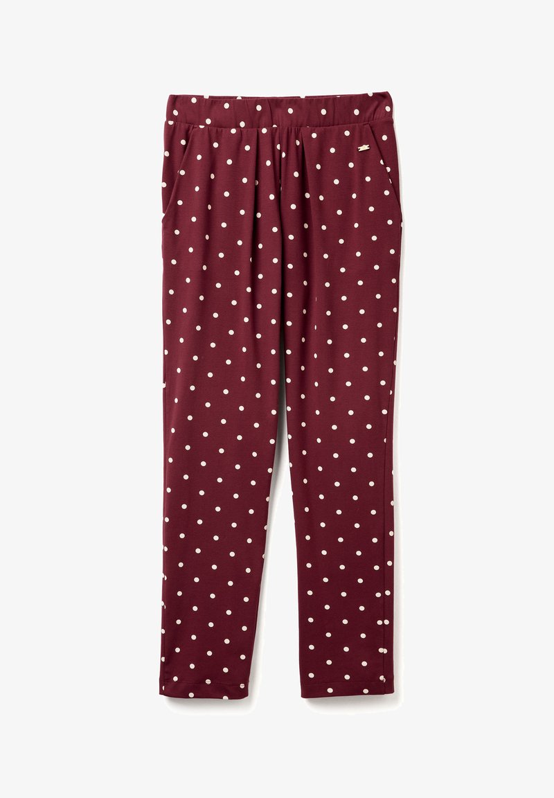 Bordeauxkleurige broek van rekbaar materiaal met witte stippen, een elastische tailleband, twee zijzakken en een taps toelopende pijp.