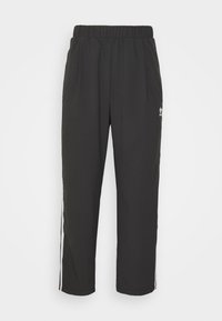 Black athletic pants with an elastic waistband, tapered legs, side stripes, and a small logo on the front. Fabric appears smooth and lightweight.