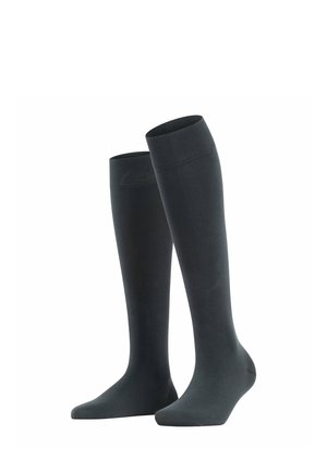 Chaussettes noires montantes en tissu extensible, avec une texture lisse, un renfort au niveau des orteils et un revers côtelé pour un maintien sécurisé.