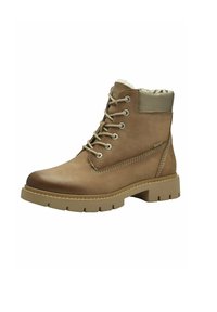 Bottines en cuir tan avec bout arrondi, semelle en caoutchouc beige clair, œillets en métal et col rembourré. Présente des détails de couture sur les côtés.