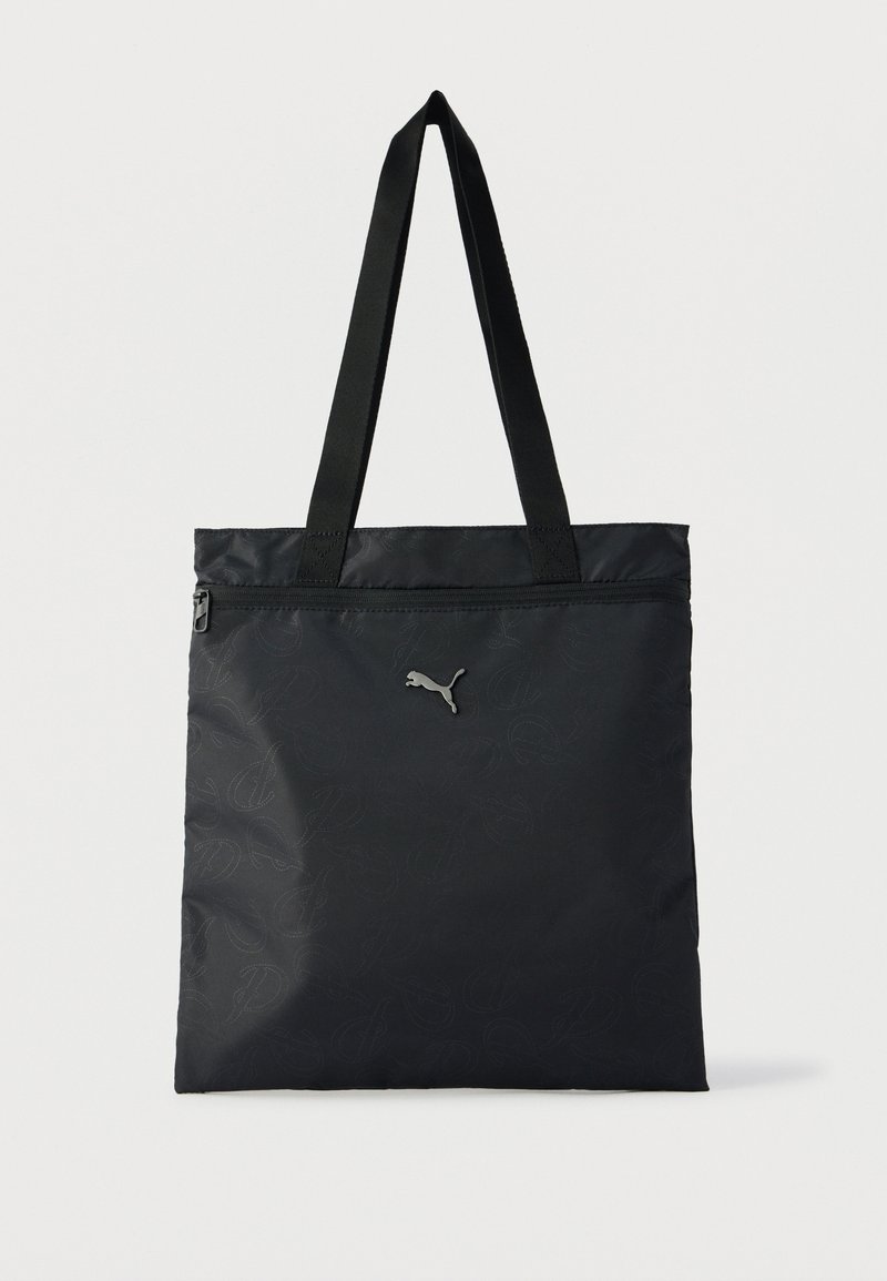 Black Puma tote bag with long handles, front zipper pocket, and subtle printed logo pattern on fabric.