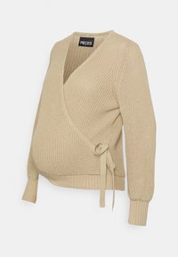 Pull en maille beige avec un col en V profond, des manches longues et un détail de nouage à la taille. Tissu texturé avec des poignets côtelés.