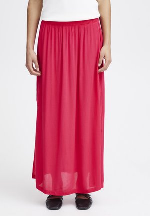 Maxi-Rock in leuchtendem Pink, aus leichtem Stoff. Verfügt über einen elastischen Bund und ein fließendes Design mit seitlichen Schlitzen. Kombiniert mit schwarzen Schuhen.