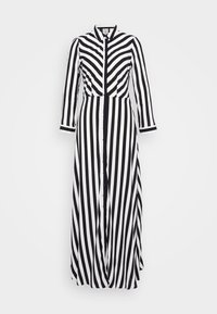 Długa, czarno-biała sukienka maxi w paski z długim rękawem, z guzikami z przodu i kołnierzykiem. Góra sukienki ma wzór w zygzaki, a spód jest w pionowe paski.