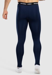 Marina leggings i stretchmaterial, med en åtsittande design och elastisk midja med "SMILODOX"-logotyp. Slät textur, ankellängd.