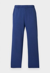 Námořnické modré, volné tepláky s elastickým pasem, vyrobené z měkké tkaniny. Jednoduchý design bez patrných vzorů nebo akcentů.