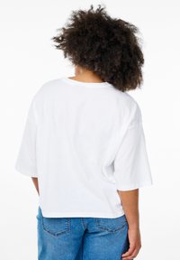 White short-sleeve T-shirt with a relaxed fit, round neck, and soft fabric. Back view shows a smooth texture without embellishments.