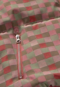 Patchwork zippered fabric featuring a grid pattern in muted pink, green, and brown tones. Glossy metal zipper accent at the center.
