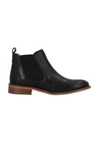 Botas Chelsea de cuero negro con paneles laterales elásticos, punta redonda y un tacón apilado en tono marrón para mayor altura y contraste.