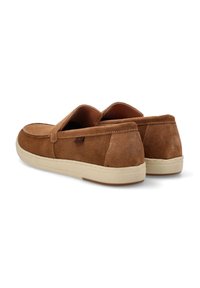Zapatos de ante marrón tipo slip-on con punta redonda y suela de goma beige. Presenta acentos de costura y un diseño de tacón plano.