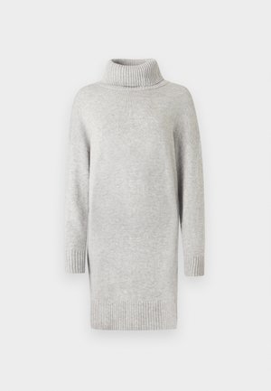 Light gray knitted sweater dress with a high ribbed turtleneck, drop shoulders, and ribbed cuffs, featuring side slits for ease of movement.